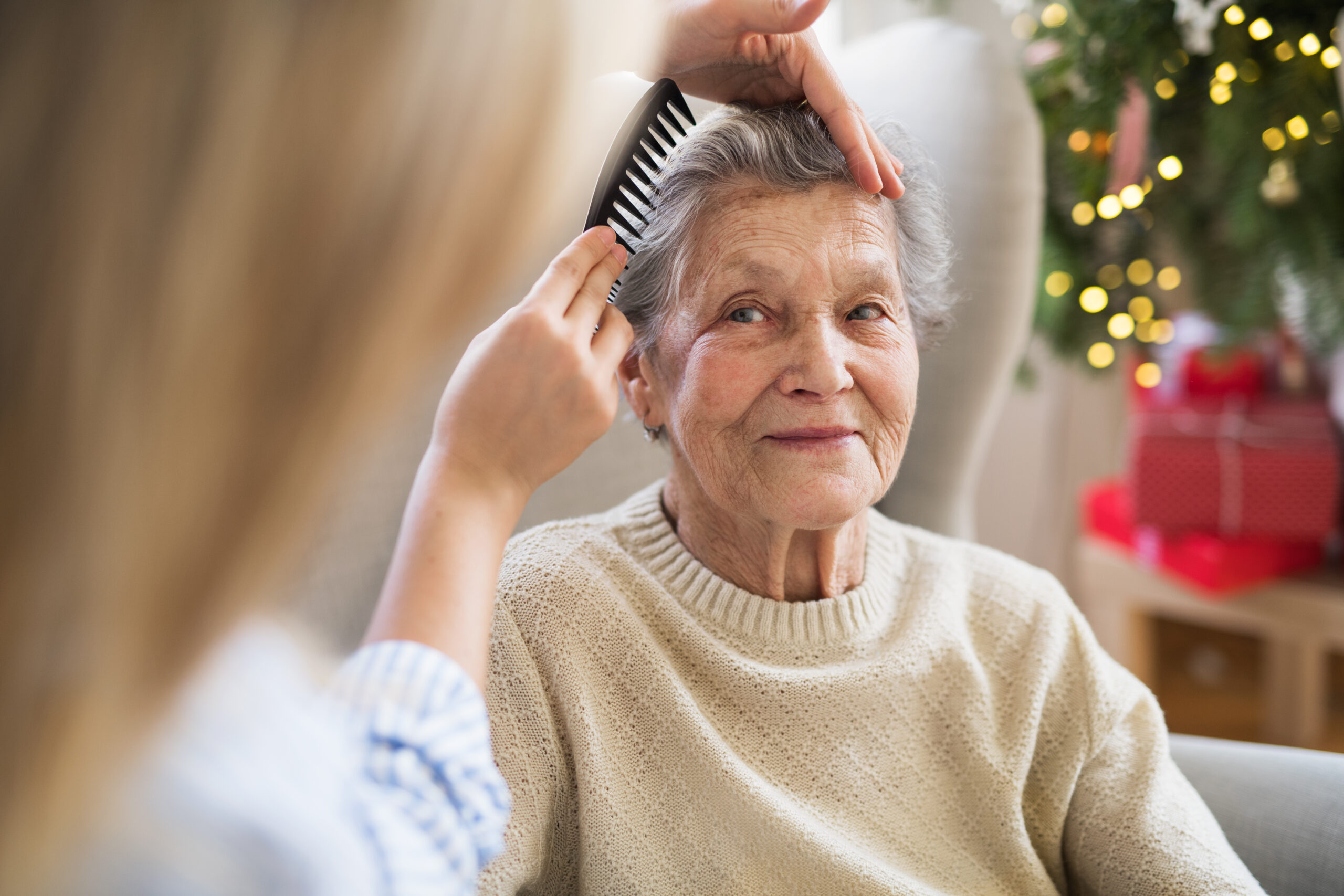 A,Health,Visitor,Combing,Hair,Of,Senior,Woman,At,Home